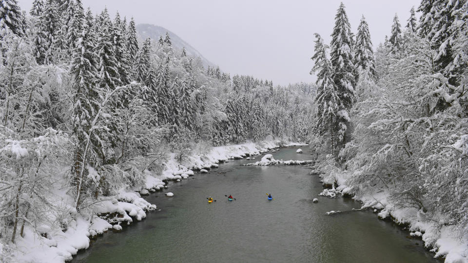 Kayaker make their way on the river Saalach on Saturday, Jan. 12, 2019 in Lofer, Austrian province of Salzburg.(AP Photo/Kerstin Joensson)