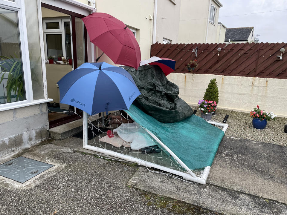 The family of the 87-year-old who fell at home were forced to build a shelter for him out of a football goal - as he waited 15 hours in the rain through the night for an ambulance. (SWNS)