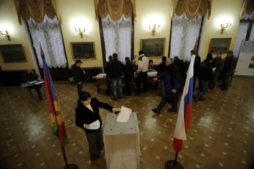 Watched over by webcams and gaggles of election observers, Russians voted in elections that exposed vastly different opinions about the merits of Vladimir Putin ahead of his expected Kremlin return