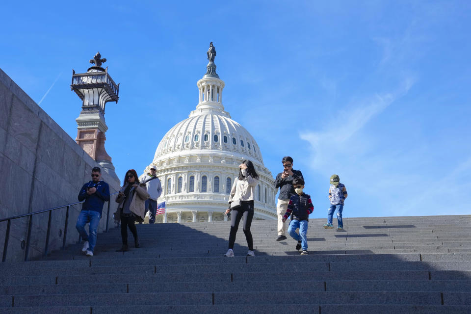 With the U.S Capitol in the background, people walk down steps on Election Day in Washington, Tuesday, Nov. 8, 2022. (AP Photo/Mariam Zuhaib)