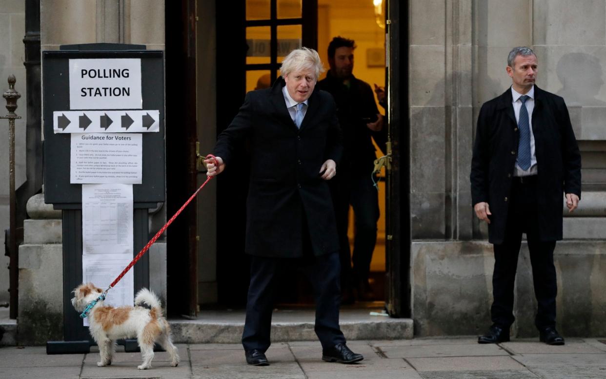 The PM casts his vote in Westminster...with a little help from a friend. - AP