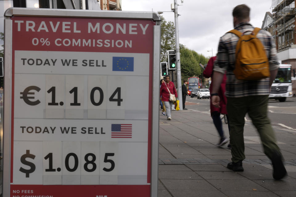 FILE - Pedestrians pass a currency exchange sign outside a shop after the pound dropped in value, in London, Sept. 23, 2022. After an acrimonious divorce and years of bickering, Britain’s government looks like it wants to make up with the European Union. Russia’s invasion of Ukraine put Brexit in perspective and brought Western allies closer together. The energy squeeze and cost-of-living crisis unleashed by the war have given governments in Britain and across Europe more pressing problems to deal with. (AP Photo/Kirsty Wigglesworth, file)