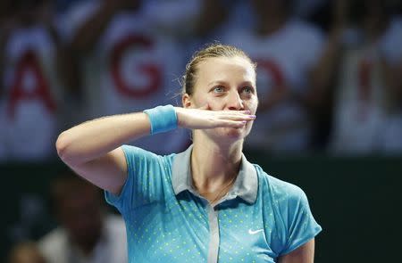 Petra Kvitova of the Czech Republic blows kisses to the audience after defeating Maria Sharapova of Russia during their WTA Finals singles tennis match at the Singapore Indoor Stadium October 23, 2014. REUTERS/Edgar Su