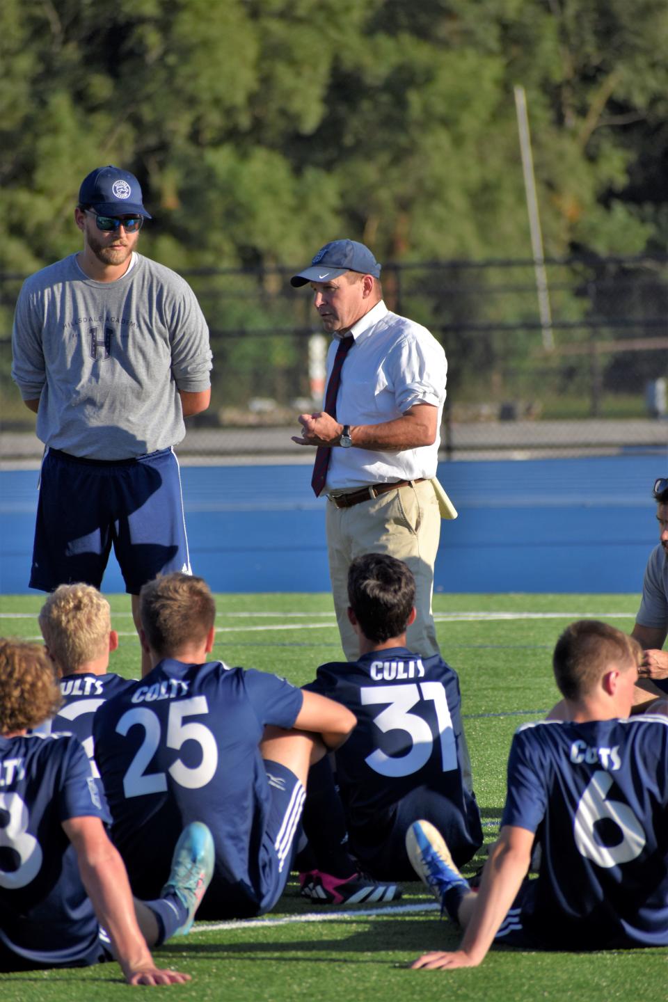Hillsdale Academy coach Neal Brady talks to the team at halftime during their first game at the new Hayden Park Stadium.