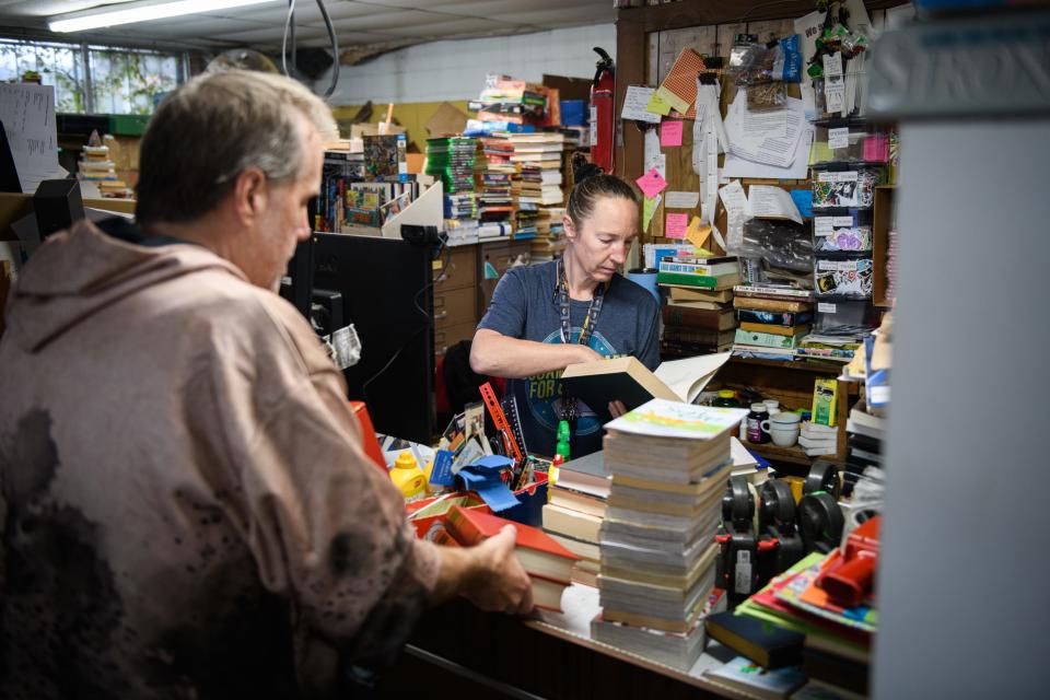 Siblings Rudy Edwards, left, and Nancy Edwards, work on pricing books at their family’s bookstore, BJ's Used Book Exchange at 4905 Murchison Road.