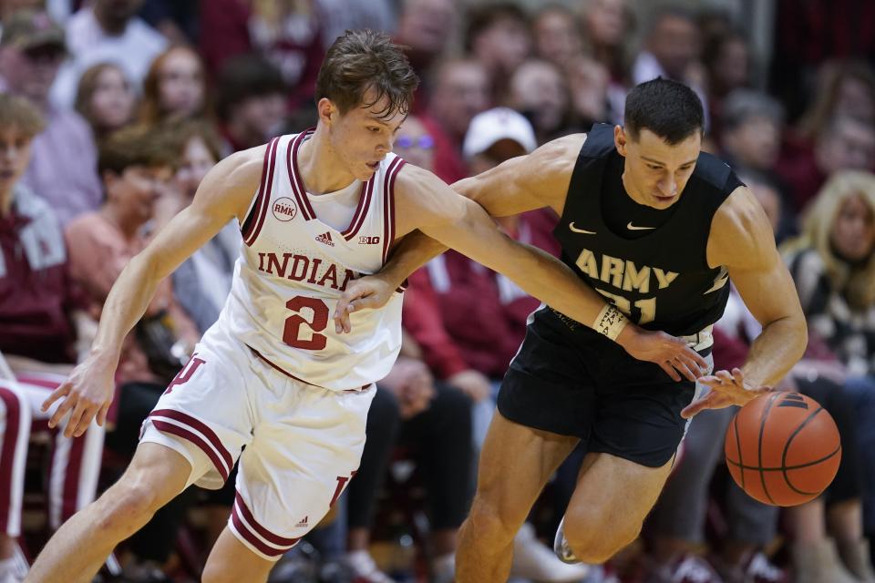 Army's Blake Barker makes a steal against Indiana's Gabe Cupps (2) during the first half of an NCAA college basketball game, Sunday, Nov. 12, 2023, in Bloomington, Ind. (AP Photo/Darron Cummings)