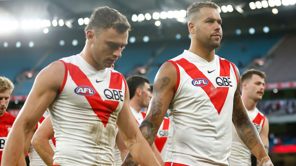 Buddy Franklin leads the Swans off the ground.