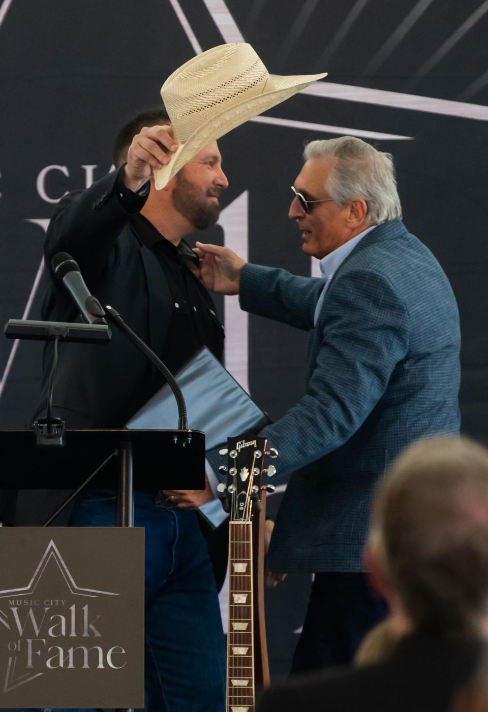 Garth Brooks hugs Nashville Convention & Visitors Corp. CEO Butch Spyridon, May 4, 2023