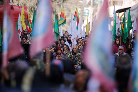 Kurdish people hold flags as they attend a rally in the Sheikh Maksoud neighbourhood of Aleppo, Syria February 7, 2018. REUTERS/Omar Sanadiki