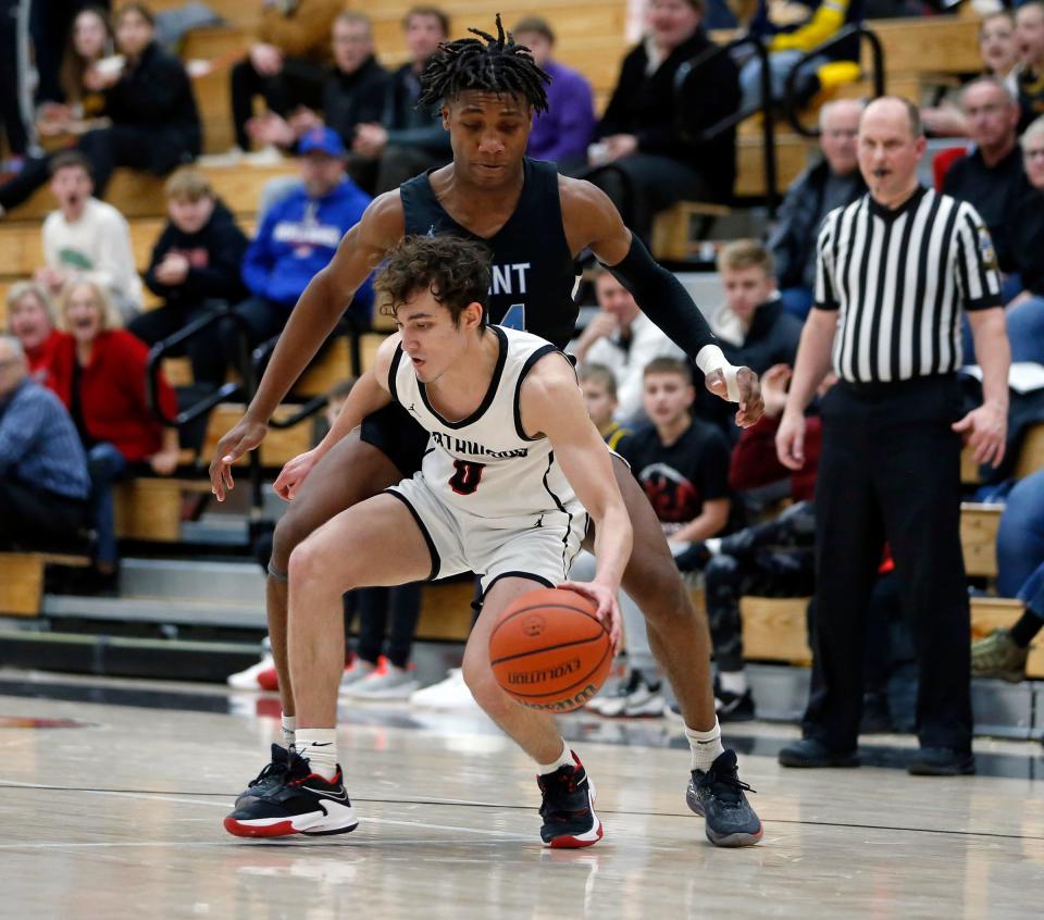 NorthWood senior Ethan Wolfe (0) looks for room to dribble while being defended by South Bend Saint Joseph senior Jayce Lee during a boys basketball game Tuesday, Jan. 16, 2024, at NorthWood High School in Nappanee.