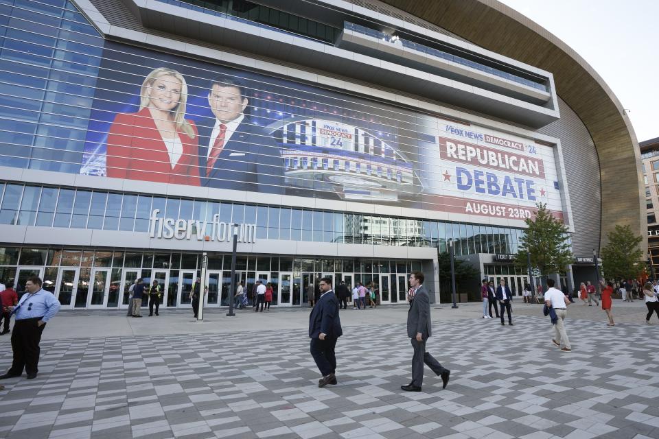 People arrive at the Fiserv Forum before a Republican presidential primary debate sponsored by Fox News Channel on Aug. 23, 2023, in Milwaukee. The focus is on Iowa this week. | Morry Gash, Associated Press