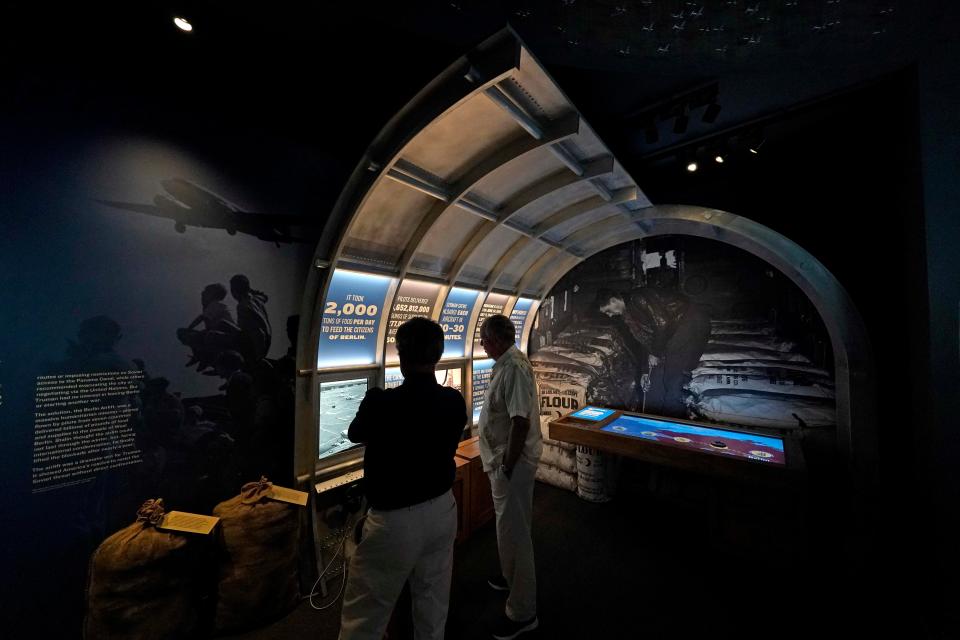 People view an exhibit about the Berlin airlift during a tour of the Harry S. Truman Presidential Library and Museum in Independence, Mo. The facility will reopen Friday after a nearly $30 million renovation project.