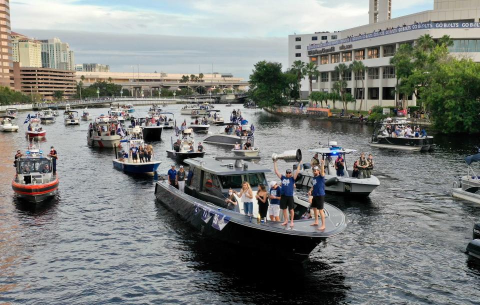 Members of the Tampa Bay Lightning make their way down the Hillsborough River as they are greeted by fans during the NHL hockey Stanley Cup champions' boat parade, Wednesday, Sept. 30, 2020, in Tampa, Fla. (Luis Santana/Tampa Bay Times via AP)