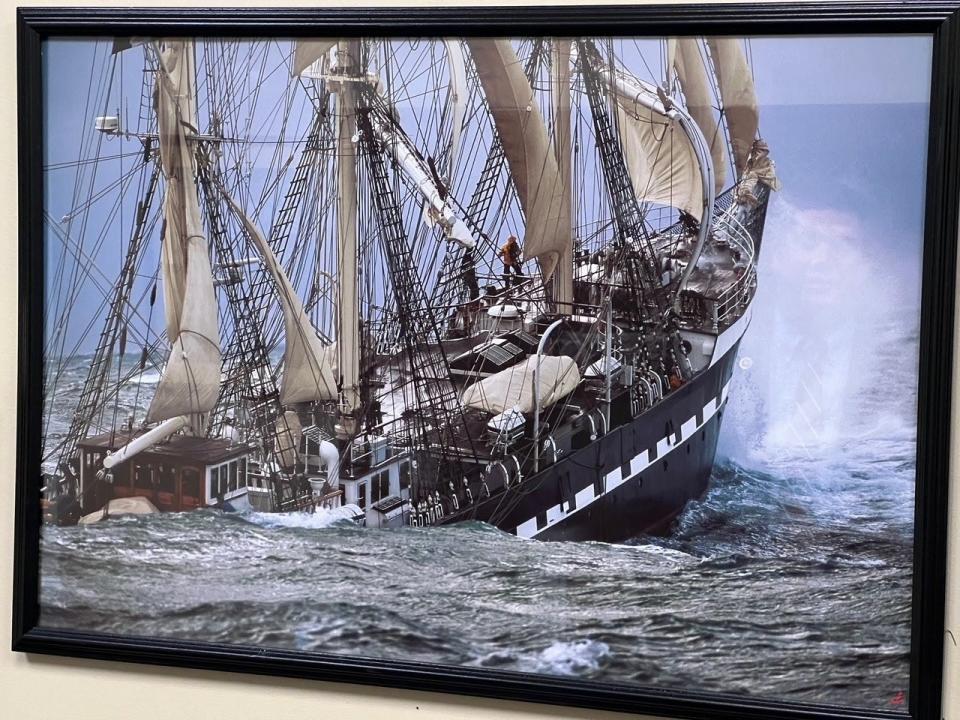 An image of a ship on the wall of Del. Chris Adams' Annapolis office on Jan. 30, 2024. Adams, in the image's reflection, said the ship is a metaphor.