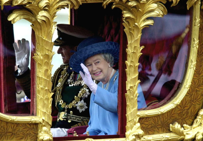 Queen Elizabeth with Prince Philip in the Gold State Coach during the procession from Buckingham Palace to St. Paul's Cathedral. <span class="copyright">Getty Images</span>