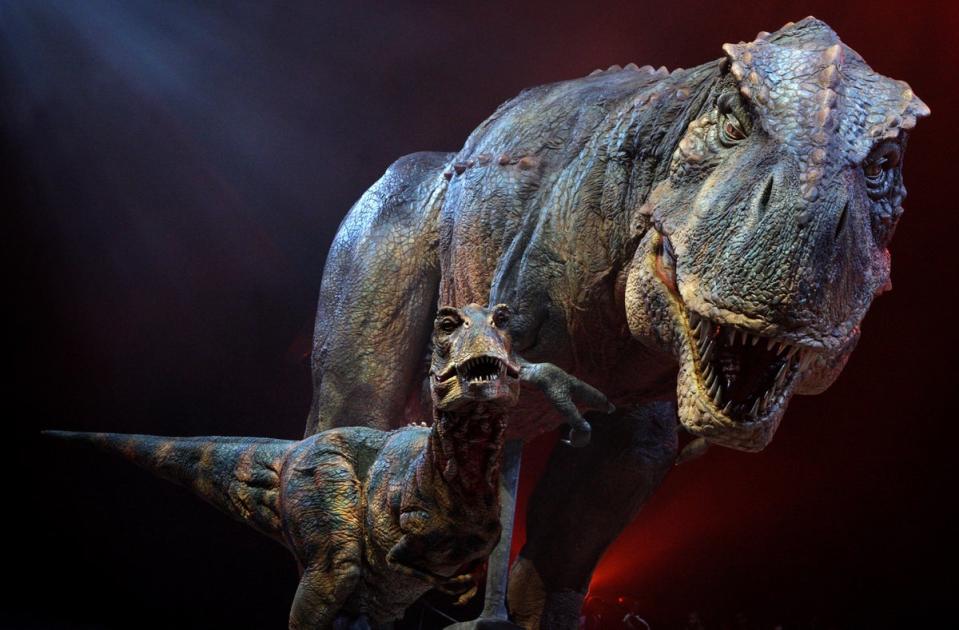 An adult and baby Tyrannosaurs Rex robotic dinosaurs perform in the O2 arena as part of the ‘Walking With Dinosaurs’ tour, based on the TV show, in 2009 (Getty Images)