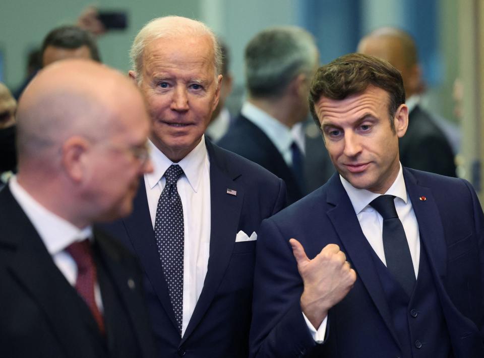 U.S. President Joe Biden (left) talks with France's President Emmanuel Macron (right) ahead of an extraordinary NATO summit at NATO Headquarters in Brussels on March 24, 2022.