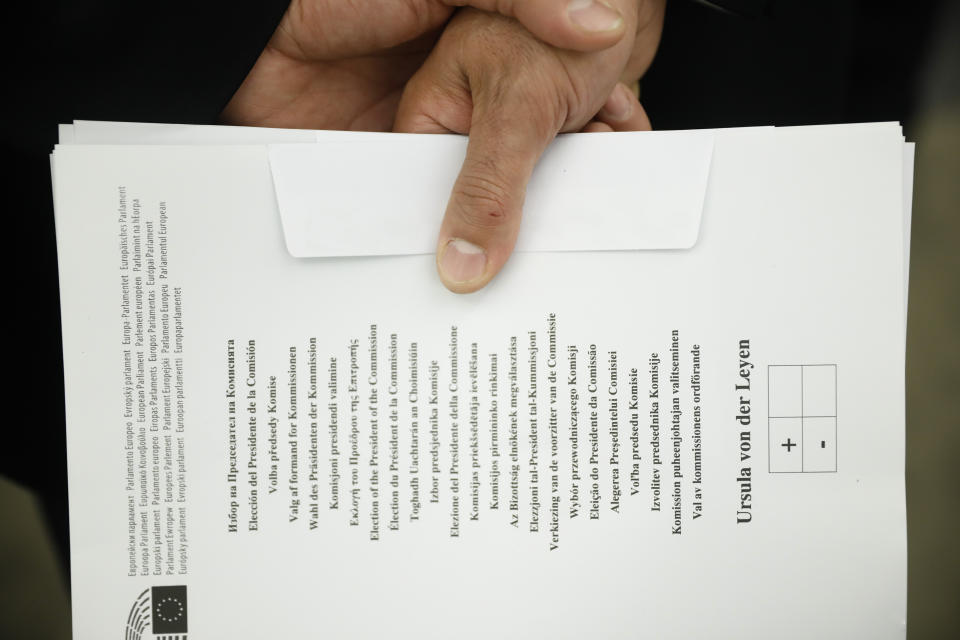 An usher holds a ballot to be used for the election of the German candidate Ursula von der Leyen as the new European Commission President at the European Parliament in Strasbourg, eastern France, Tuesday, July 16, 2019. (AP Photo/Jean-Francois Badias)