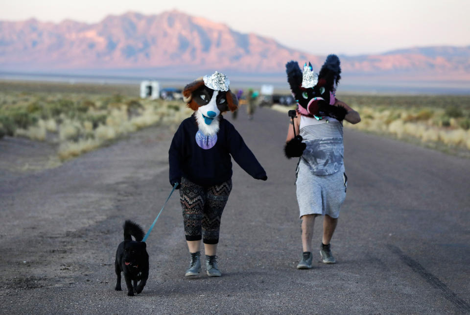 People dressed in costumes walk to an entrance to Area 51 as an influx of tourists responding to a call to 'storm' Area 51, a secretive U.S. military base believed by UFO enthusiasts to hold government secrets about extra-terrestrials, is expected in Rachel, Nevada, U.S. September 20, 2019. REUTERS/Jim Urquhart