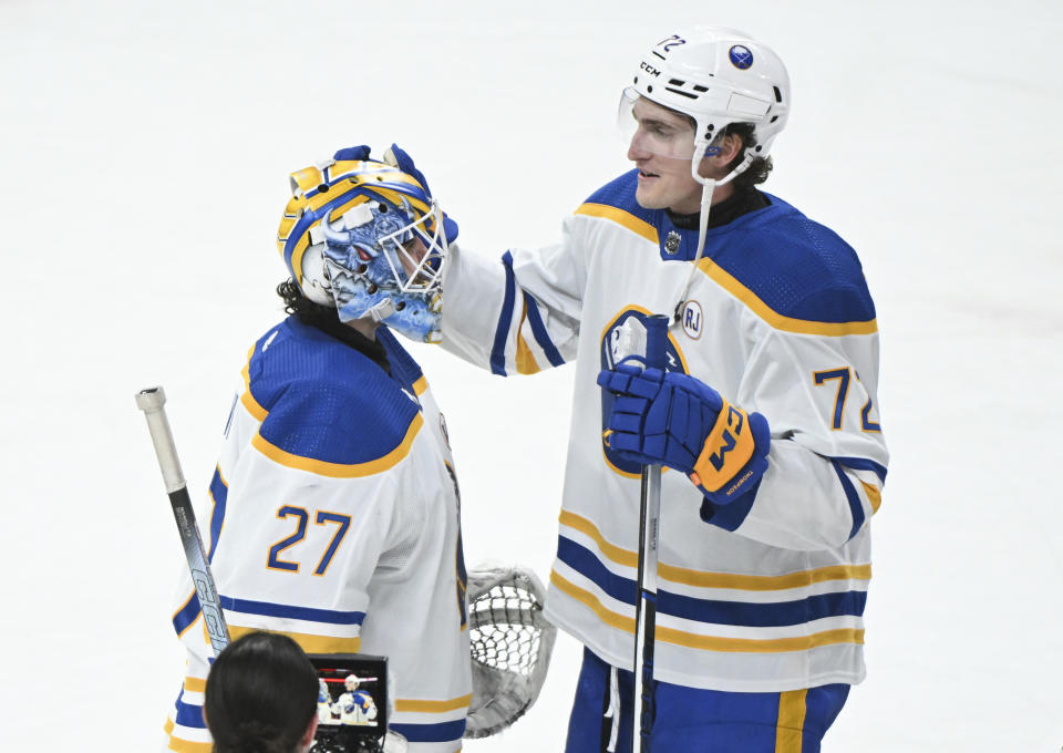 Buffalo Sabres goaltender Devon Levi (27) celebrates with Tage Thompson (72) after the team's win over the Montreal Canadiens in an NHL hockey game Thursday, Jan. 4, 2024, in Montreal. (Graham Hughes/The Canadian Press via AP)