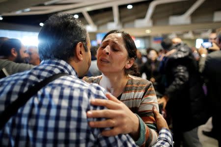 Christian Syrian refugee Samira Aleid (R), 45, hugs her cousin Emmanuel Aleid, 37, as she arrives with fifteen members of her family from Beirut, at the Charles-de-Gaulle Airport in Roissy, France, October 2, 2015. REUTERS/Stephane Mahe