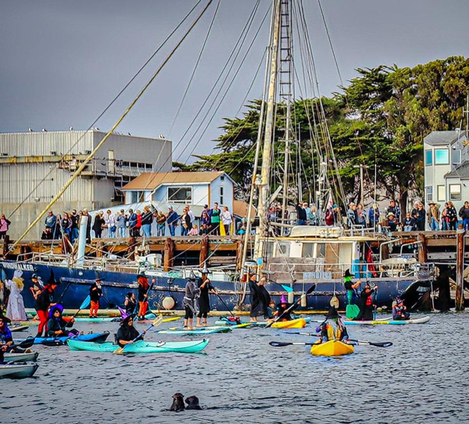 People dressed as witches and warlocks participate in the ninth annual Morro Bay Witches Paddle on Saturday, Oct. 22, 2022.