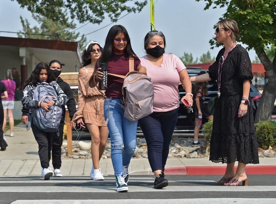 Parents pick up their children after the first day of school at Jessie Beck Elementary in Reno, Nev., on Aug. 9.