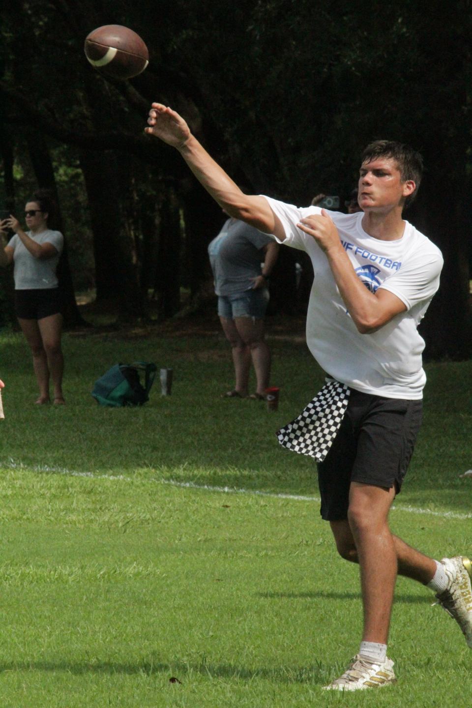 A quarterback releases the ball during some independent quarterback drills at the UWF football camp on Saturday, July 15, 2023.