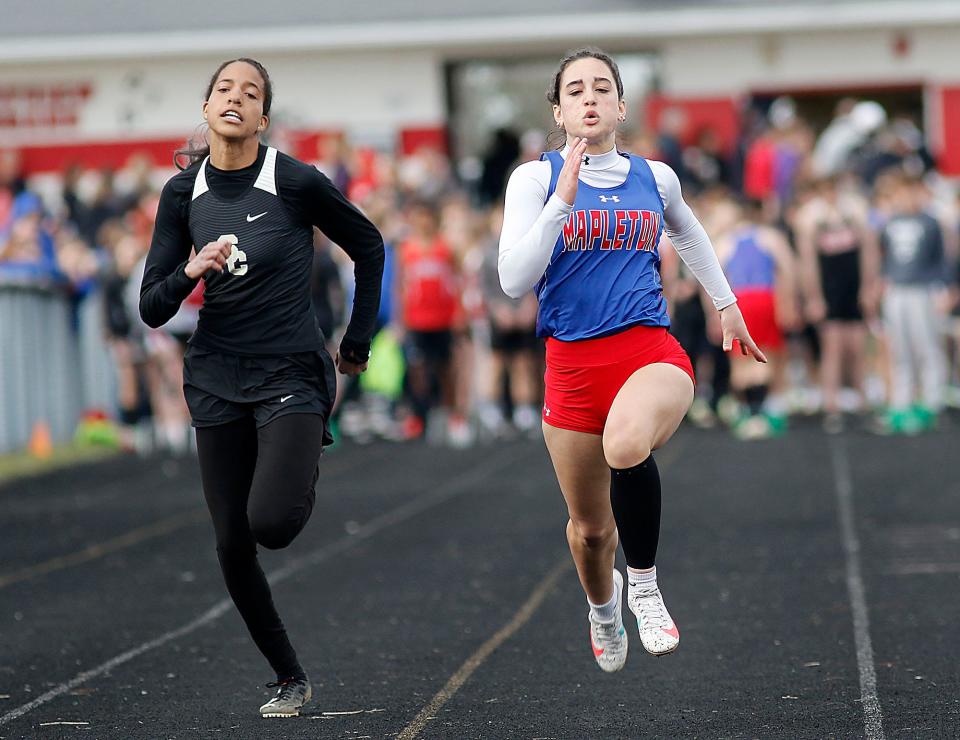 South Central's Angela Williams and Mapleton's Jillian Carrick compete in the 100 meter dash during the Forest Pruner Track Invitational at Crestview High School on Friday, April 22, 2022. TOM E. PUSKAR/TIMES-GAZETTE.COM