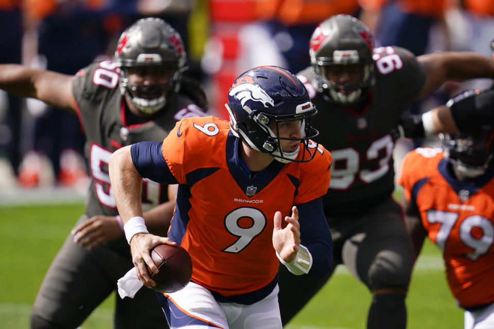 Denver Broncos quarterback Jeff Driskel scrambles under pressure from Tampa Bay Buccaneers nose tackle Vita Vea, left, and defensive end Ndamukong Suh, right, during the first half of an NFL football game Sunday, Sept. 27, 2020, in Denver. (AP Photo/David Zalubowski)