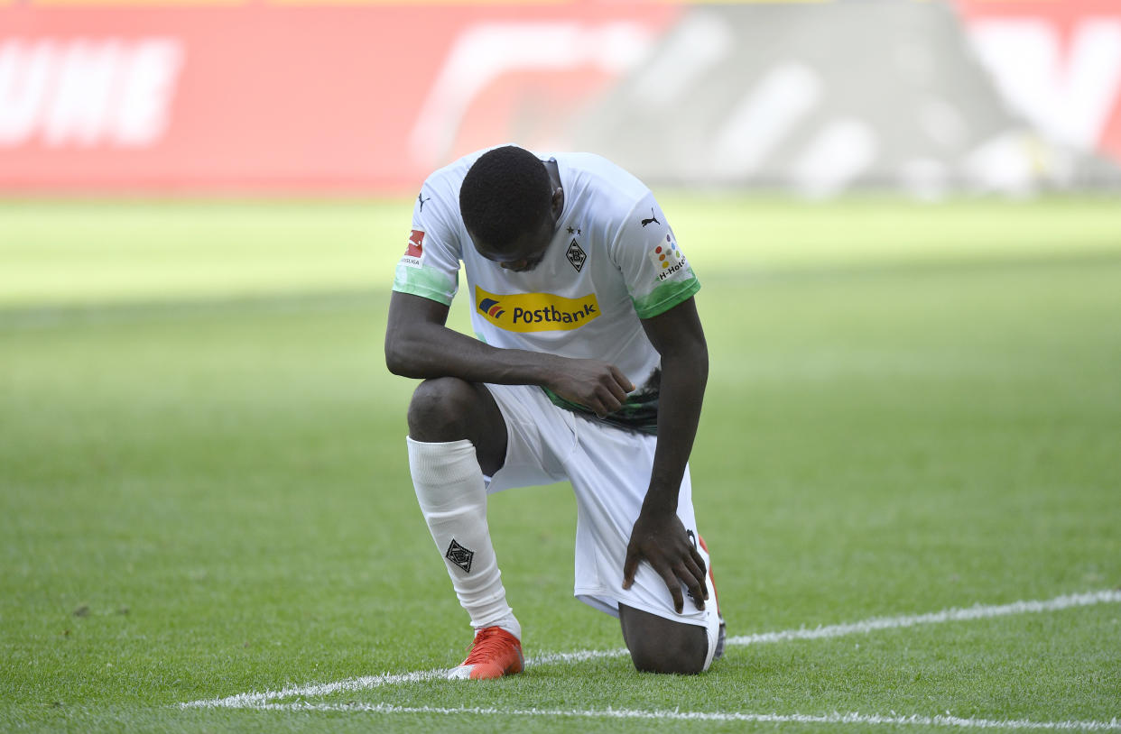 Moenchengladbach's Marcus Thuram reacts after scoring his side's second goal during the German Bundesliga soccer match between Borussia Moenchengladbach and Union Berlin in Moenchengladbach, Germany, Sunday, May 31, 2020. The German Bundesliga becomes the world's first major soccer league to resume after a two-month suspension because of the coronavirus pandemic. (AP Photo/Martin Meissner, Pool)
