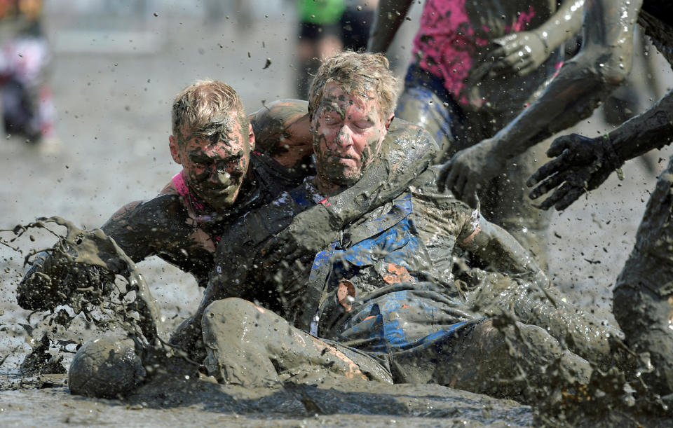 <p>Participants fight for the ball during a handball match at the so called “Wattoluempiade” (Mud Olympics) in Brunsbuettel at the North Sea, Germany July 30, 2016. (REUTERS/Fabian Bimmer) </p>