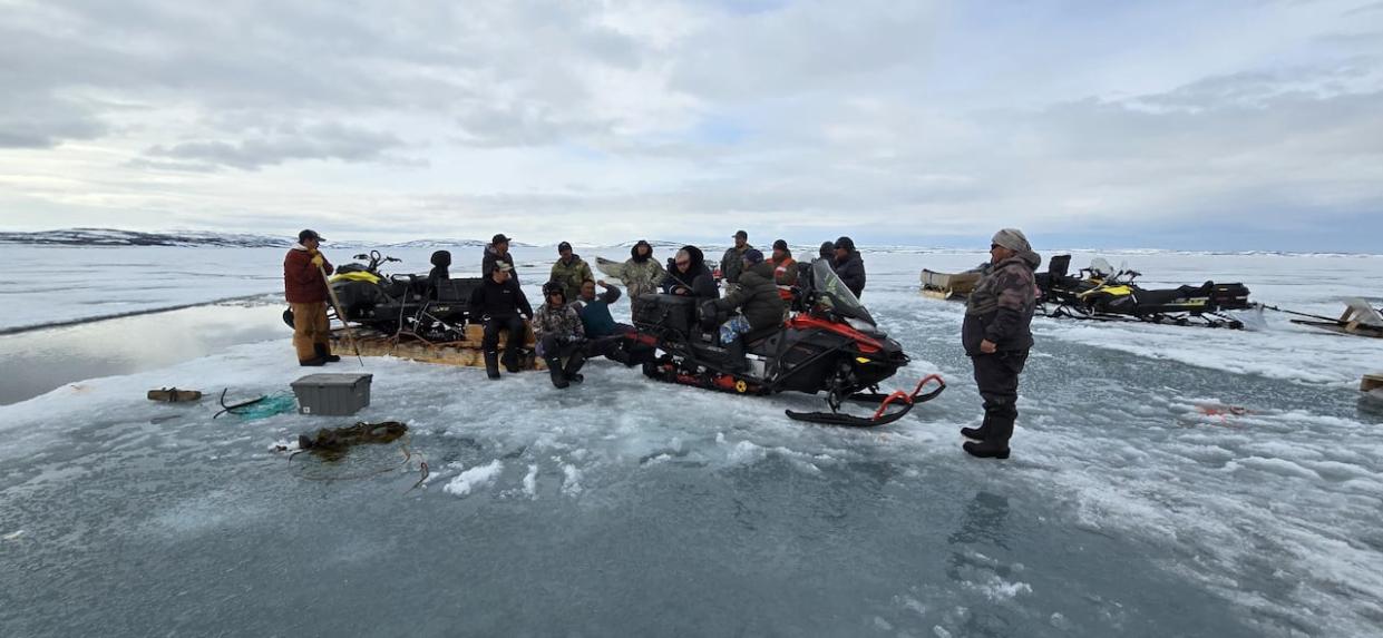 Searchers near Kangiqsujuaq, Nunavik, recovered a snowmobile from below the sea ice after 2 people went through a crack in the ice. The body of one person was found, the other is still missing. (Submitted by Naalak Mifsud  - image credit)