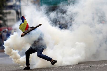 A demonstrator clashes with riot security forces during a rally against Venezuela's President Nicolas Maduro's government in Caracas, Venezuela, July 22, 2017. REUTERS/Ueslei Marcelino