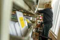 Election workers Madison Takala, left, and Mary Pluszczynsky file returned absentee ballots ahead of Tuesday's general election at the city clerk office in Warren, Mich., Wednesday, Oct. 28, 2020. (AP Photo/David Goldman)