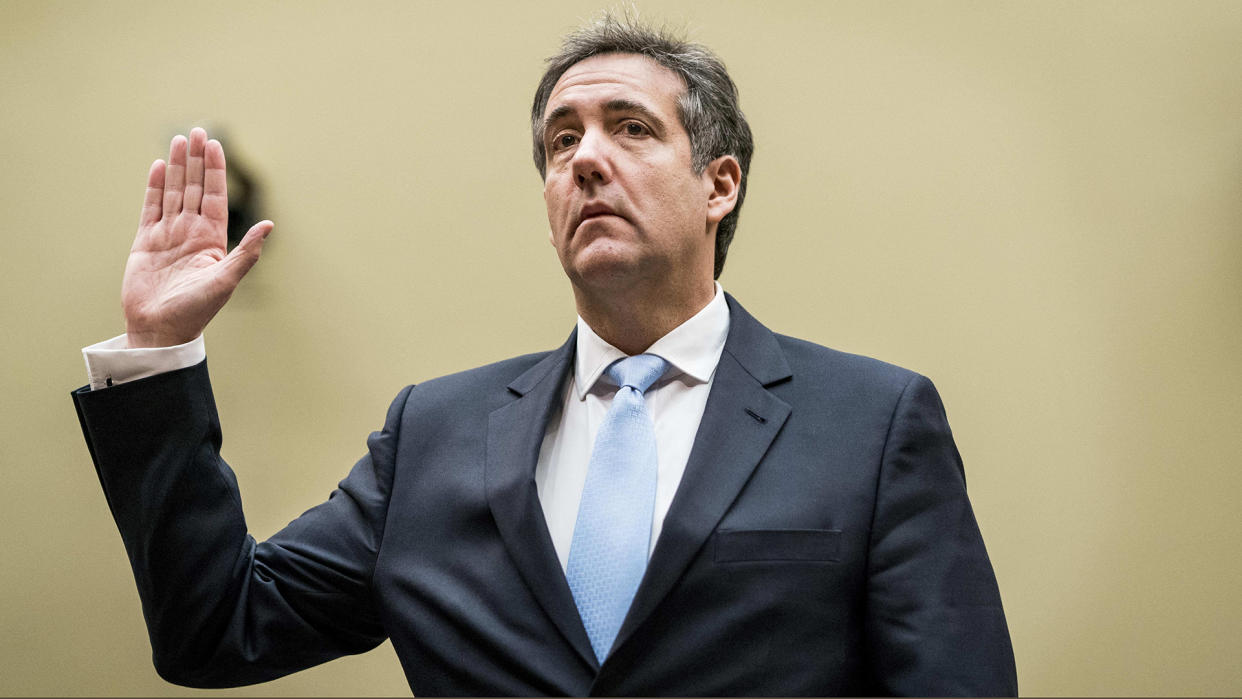 Michael Cohen raises his hand to take the oath.