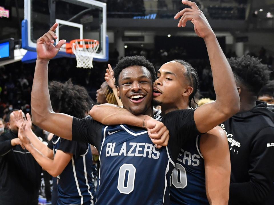 Bronny James #0 and Amari Bailey #10 of Sierra Canyon (CA) celebrate after defeating Glenbard West (IL) at Wintrust Arena on February 5, 2022