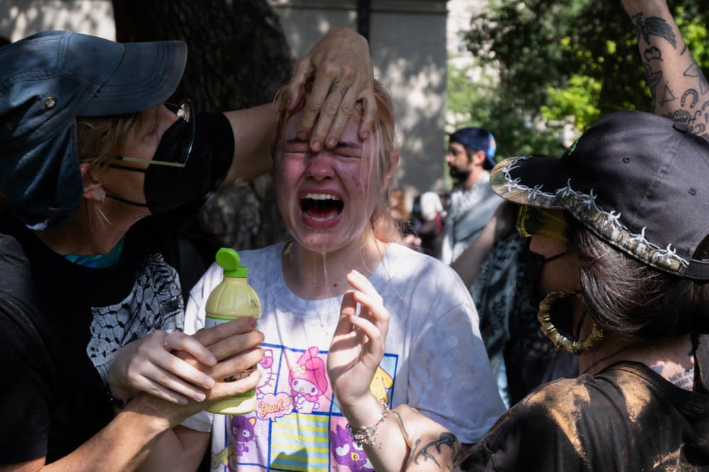 People pour liquid on a protester's face to help relieve the pain of getting pepper-sprayed on UT Austin's campus on April 29. <span class="copyright">Charlotte Keene for The Daily Texan</span>