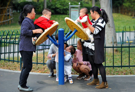 Women play with children at a park in Jinhua, Zhejiang province, China November 5, 2018. REUTERS/Stringer