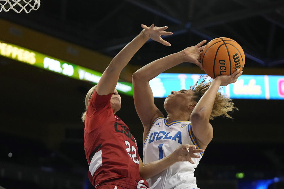 UCLA guard Kiki Rice, right, shoots as Cal State Northridge guard Kaitlyn Elsholz defends during the first half of an NCAA college basketball game Thursday, Dec. 7, 2023, in Los Angeles. (AP Photo/Mark J. Terrill)