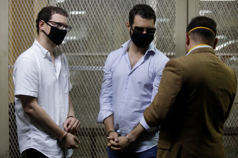 Ricardo (2nd L) and Luis Enrique, sons of former Panamanian President Ricardo Martinelli, talk to their lawyer after being detained to face extradition to the U.S. on money laundering charges, in Guatemala City