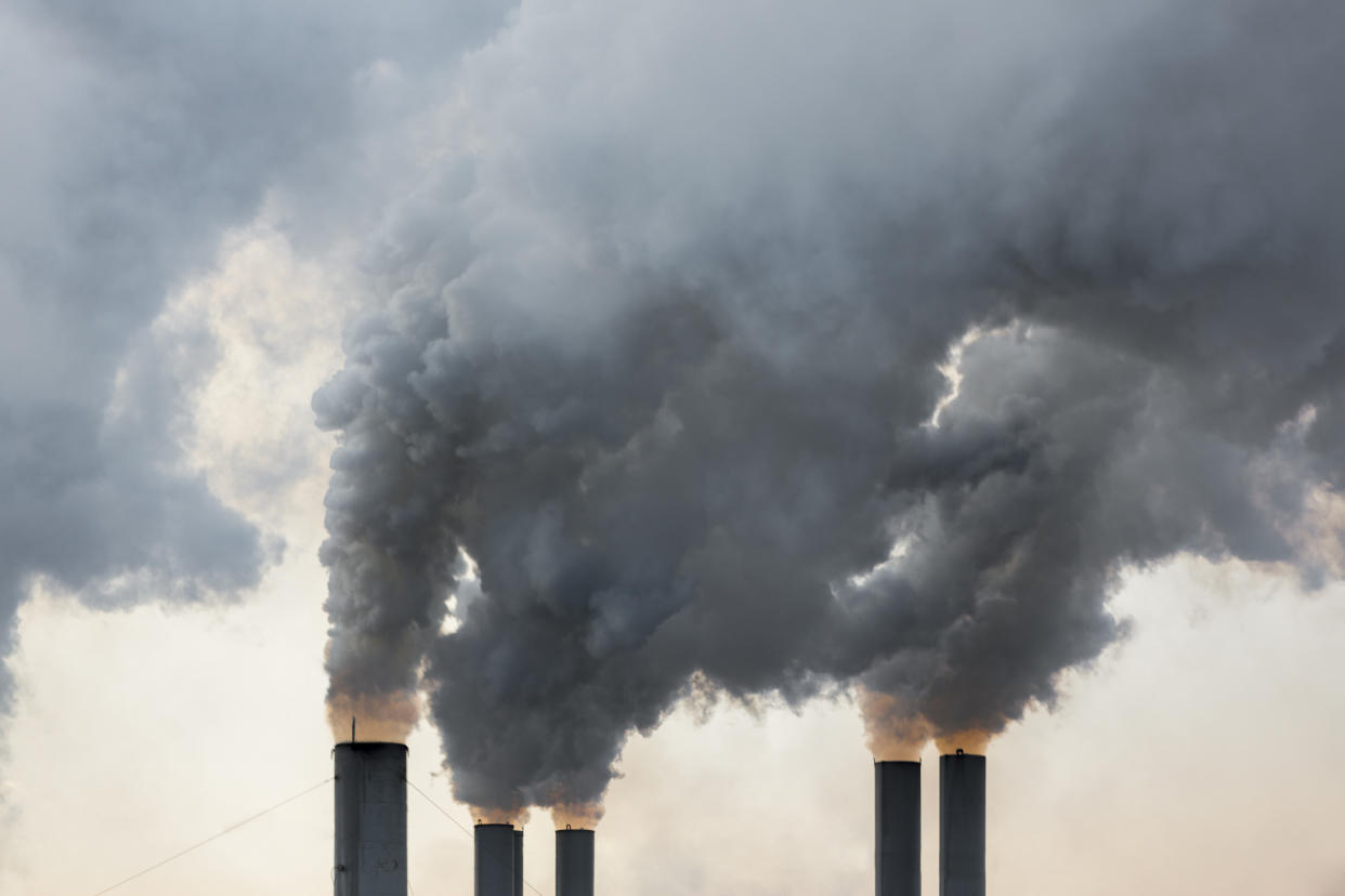 Plumes of smoke rise from chimneys at an industrial area in Greece.