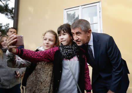 The leader of ANO party Andrej Babis poses for a selfie with young supporters as he arrives to cast his vote in parliamentary elections in Prague, Czech Republic October 20, 2017. REUTERS/David W Cerny