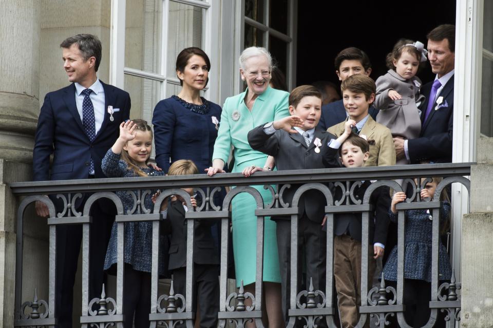 Queen Margrethe (c) of Denmark, with (L-R) Crown Prince Frederik, Princess Isabella, Crown Princess Mary, Prince Vincent (hidden behind bars), Prince Christian, Prince Nikolai (blue jacket), Prince Felix (brown jacket), Prince Henrik (dark blue jacket), Princess Athena, Prince Joachim and Princess Josephine in 2015. (Niels Ahlmann Olesen/AFP via Getty Images)