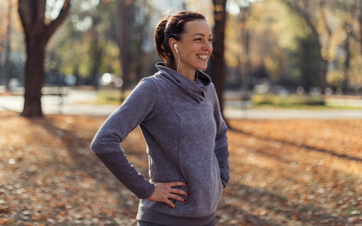 Girl catching breath after morning run - Getty