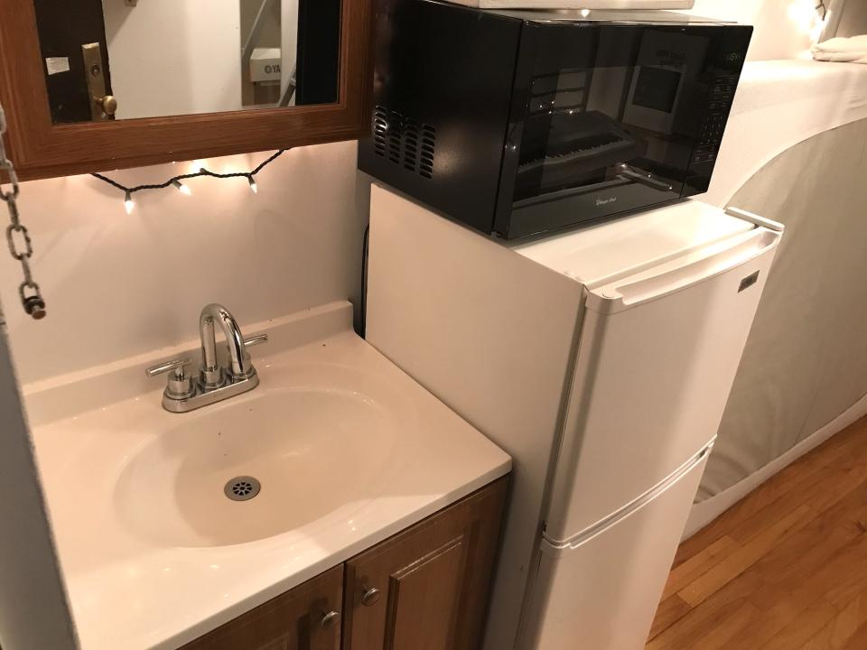 Axel Webber's kitchen, with a sink, mini fridge, and microwave