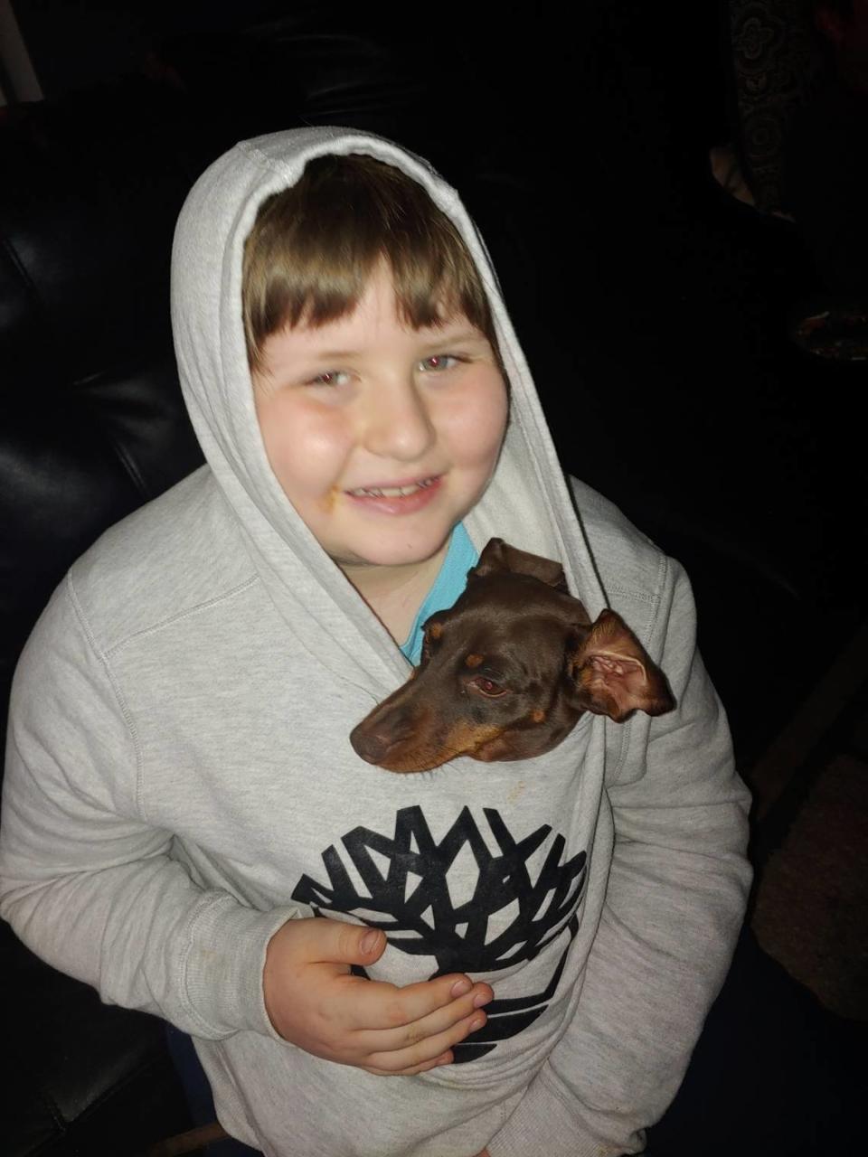 Gage Andrews, 9, shown with his dog Angel, is at the center of a new lawsuit alleging years of abuse by his former special education teacher in Statesville.