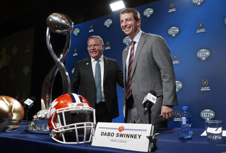 Notre Dame head coach Brian Kelly, left, and Clemson head coach Dabo Swinney smile after concluding the NCAA Cotton Bowl football coaches' news conference in Dallas, Friday, Dec. 28, 2018. Notre Dame is scheduled to play Clemson in the NCAA Cotton Bowl semi-final playoff Saturday. (AP Photo/LM Otero)