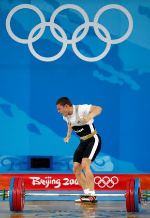 Alexandru Dudoglo of Moldova reacts after lifting 172kg in the men's 69kg Group B clean and jerk weightlifting competition at the Beijing 2008 Olympic Games August 12, 2008. REUTERS/Yves Herman