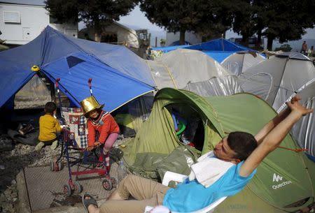 Children play near tents at a makeshift camp for migrants and refugees at the Greek-Macedonian border near the village of Idomeni, Greece, April 19, 2016. REUTERS/Stoyan Nenov